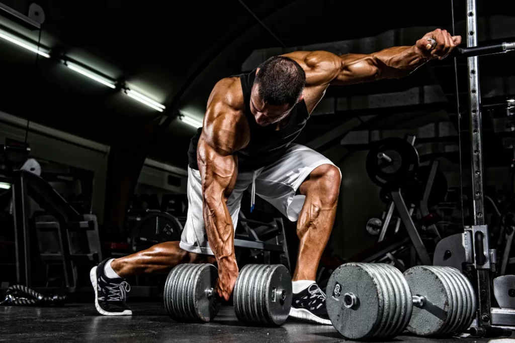 A muscular man weighing dumbbell. 