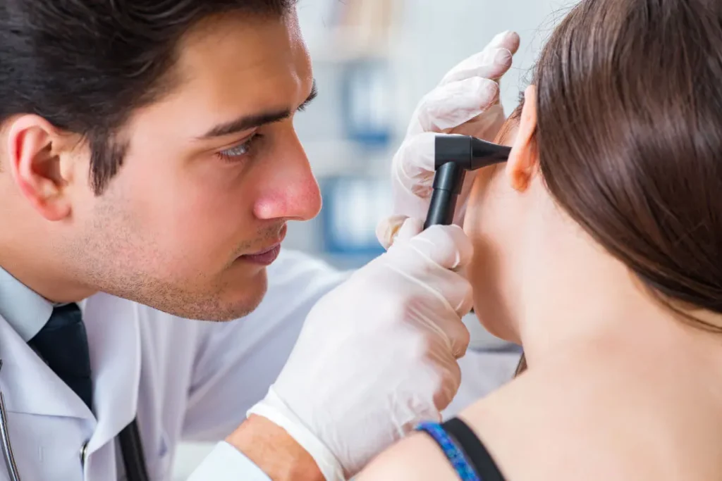 Doctor checking patient's ear.