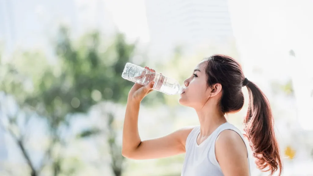 Lady is drinking water. 