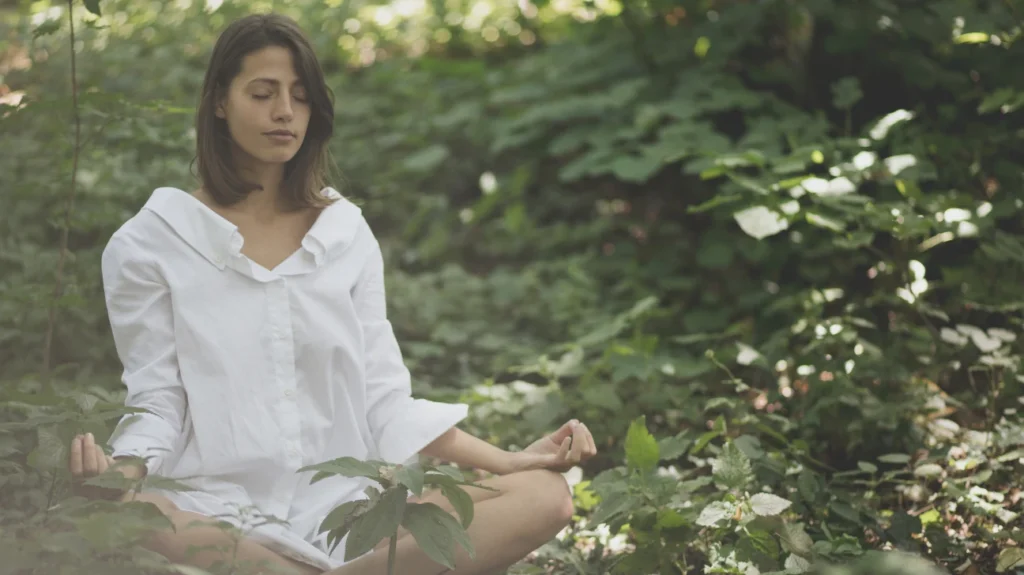 Girl doing meditation in forest